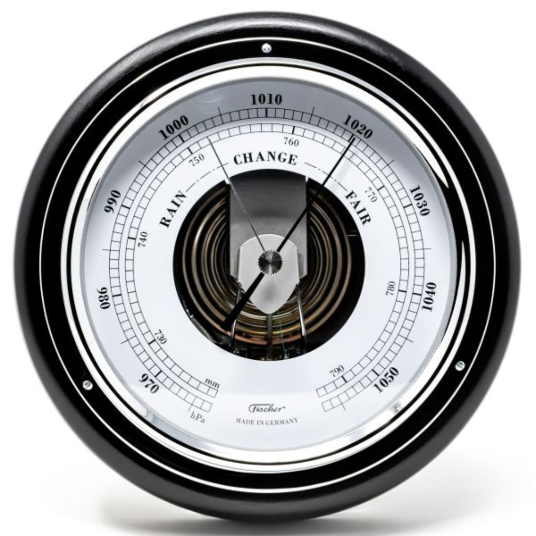 Round analog barometer with black frame and white dial showing pressure readings.