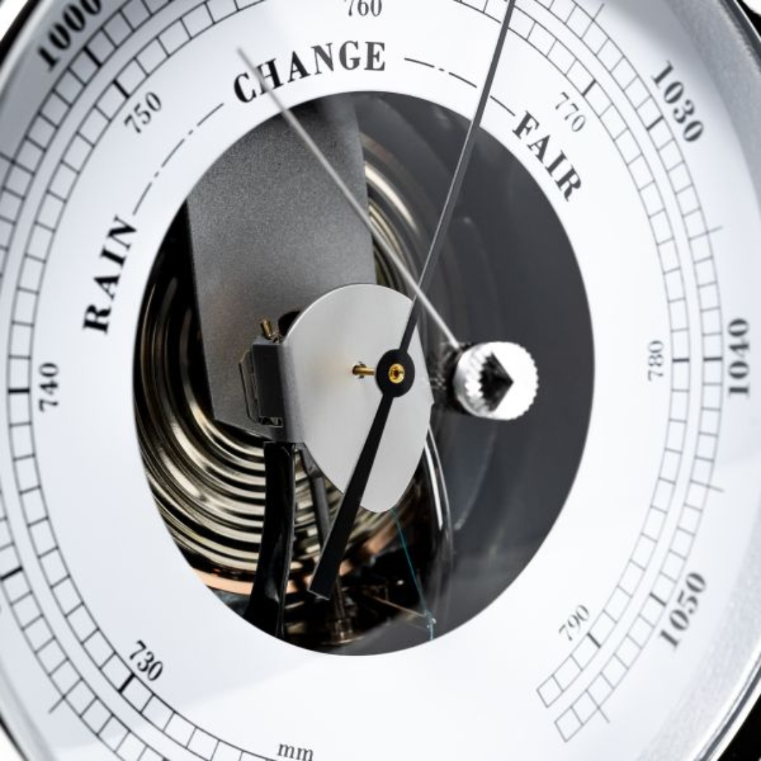 Close-up of an analog barometer dial showing weather readings, German precision instrument