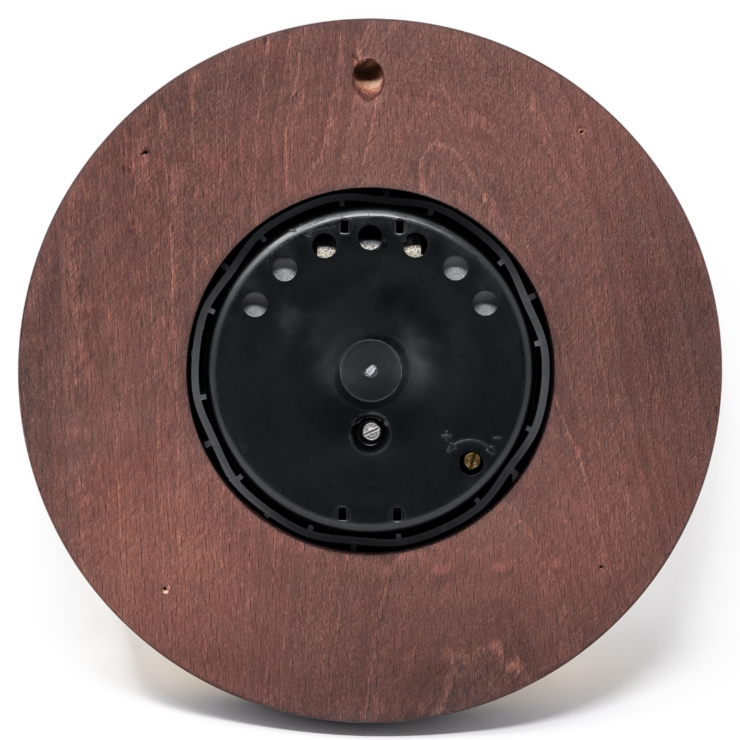 Back view of a round wooden wall clock case with mounting hole and black battery compartment