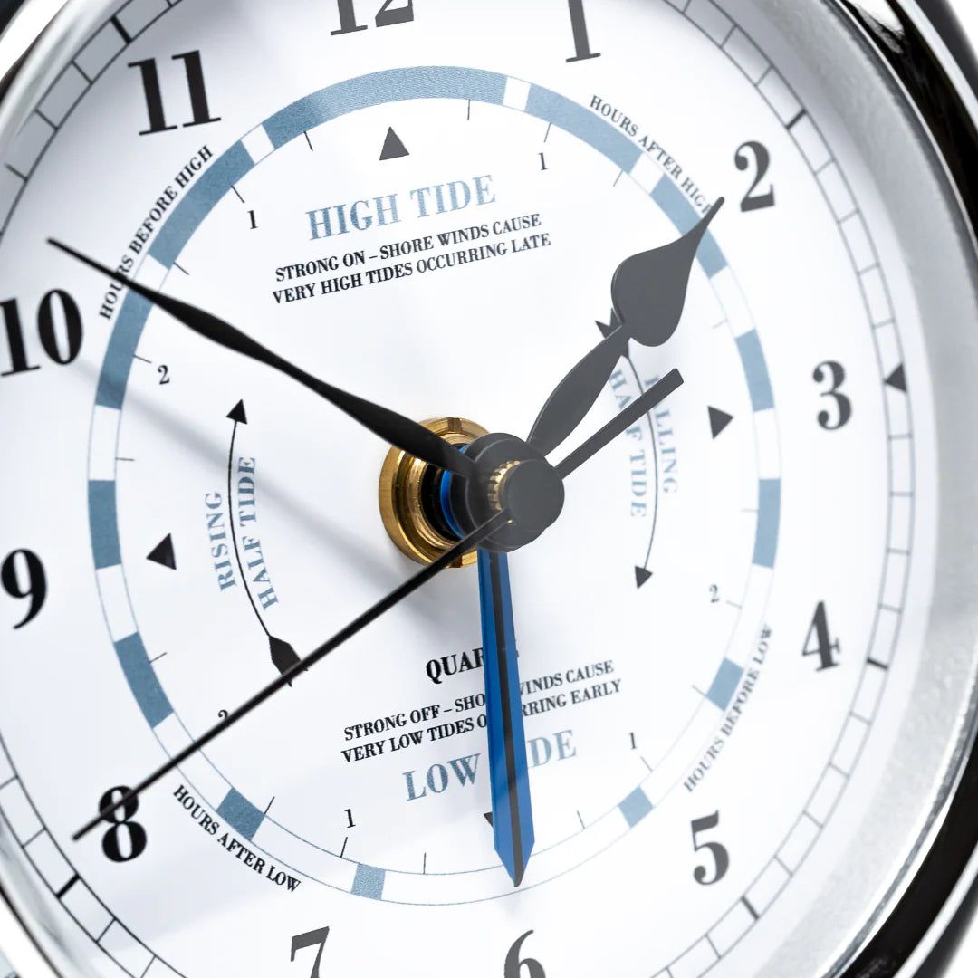 Close-up of a nautical tide clock face showing high and low tide indicators