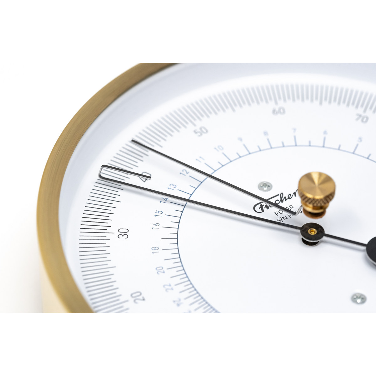 Close-up of analog German barometer with brass trim and precise measurement dial
