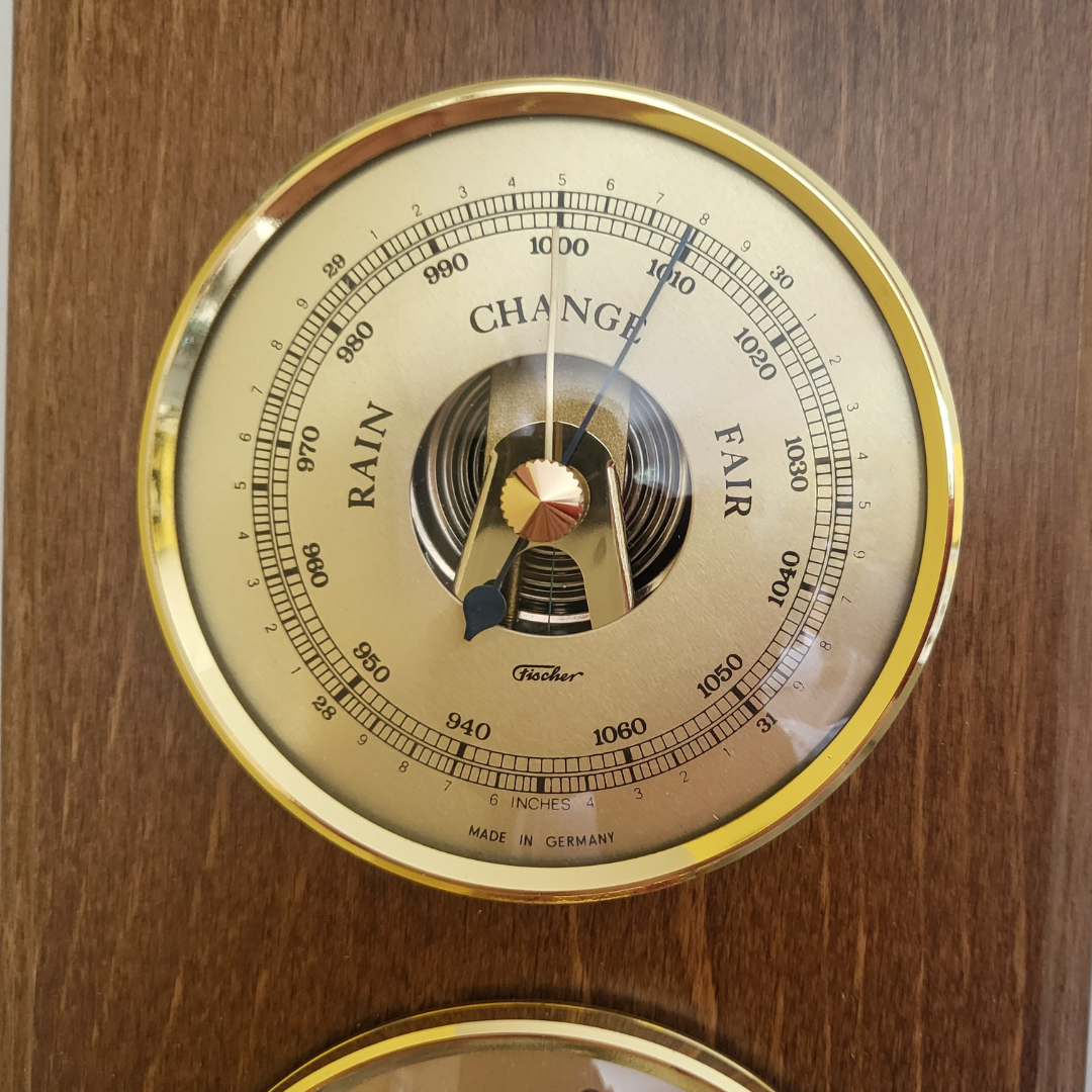 German made analog barometer with gold dial on wood panel, weather station instrument