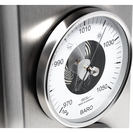 Close-up of an analog German-made barometer with hPa scale and metallic housing