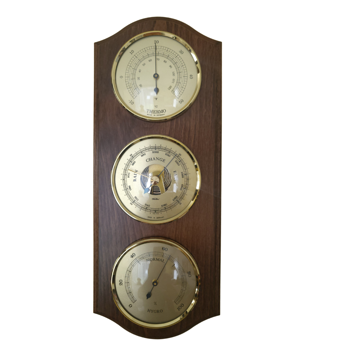 Classic wooden weather station with barometer, thermometer, and hygrometer dials
