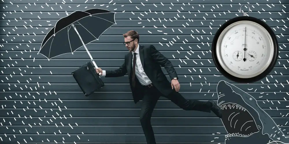 Man holding umbrella with fischer germany precision barometer to tell him the weather and a shark biting his foot