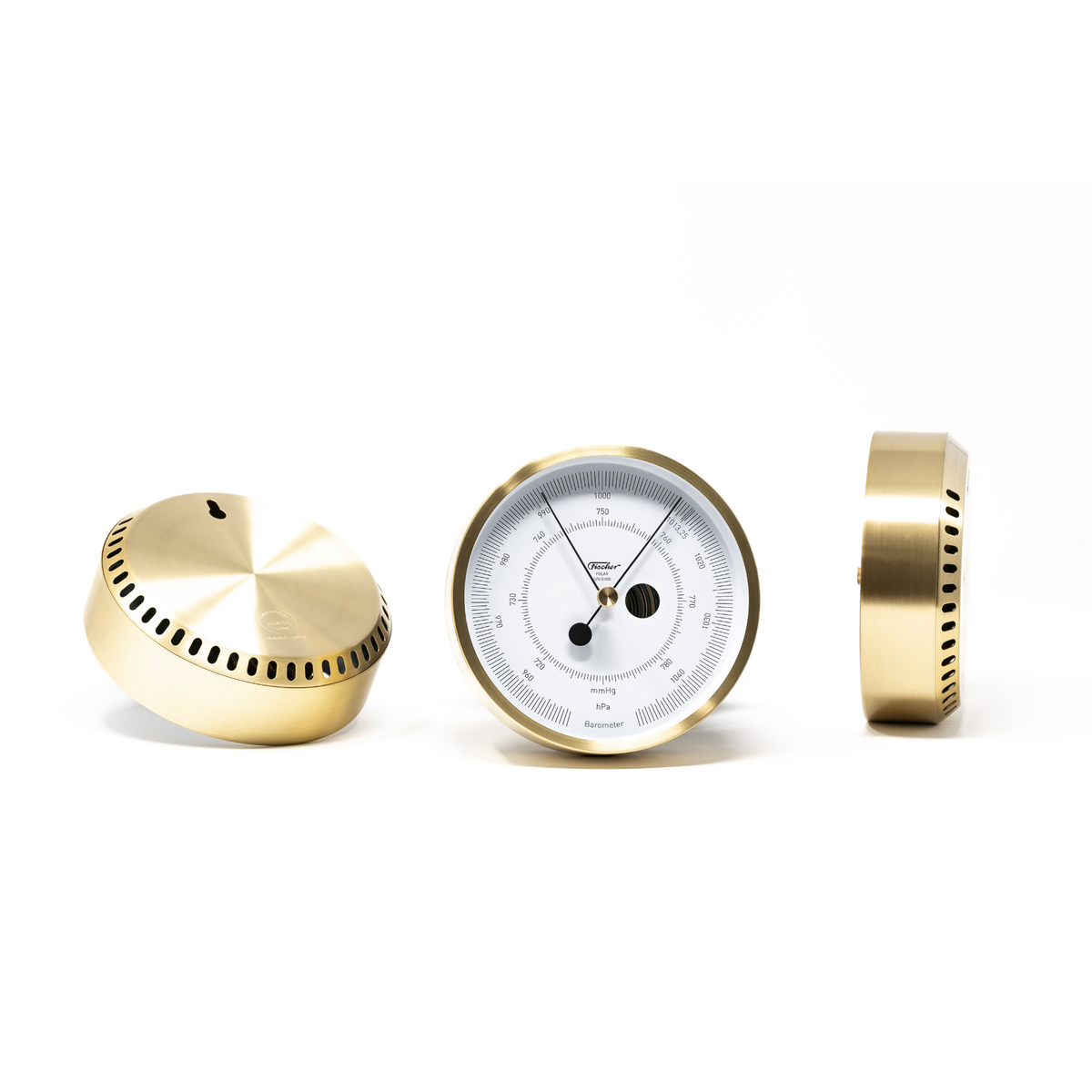 Brass analog barometer with white dial and vented casing, weather instrument display