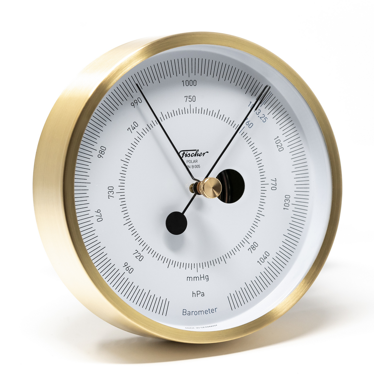 Round brass barometer with white face, black markers, precision weather instrument